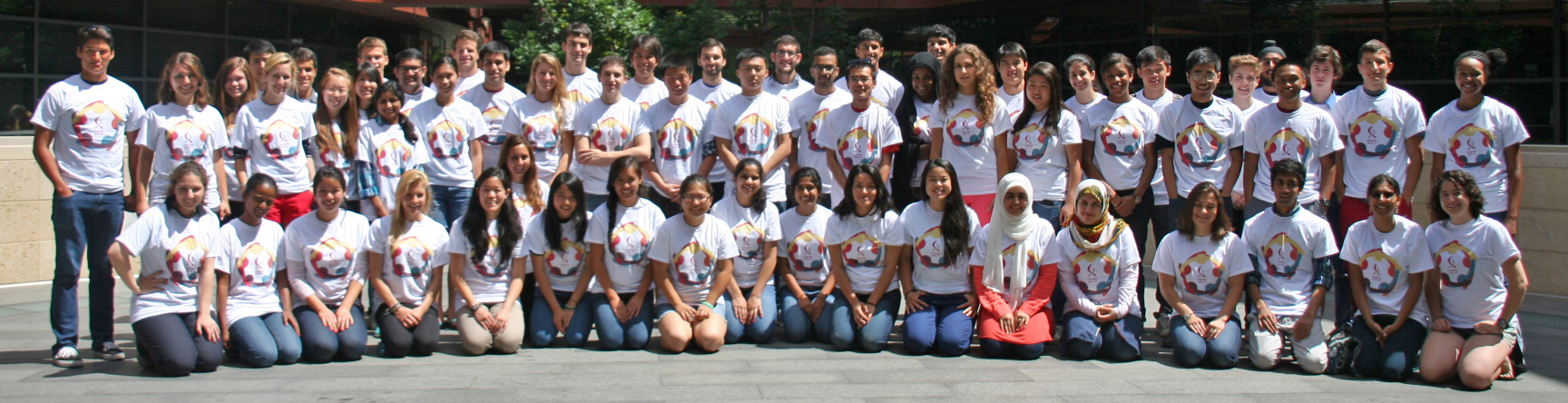 Photo of 75 undergraduates standing together at Clark in matching shirts.