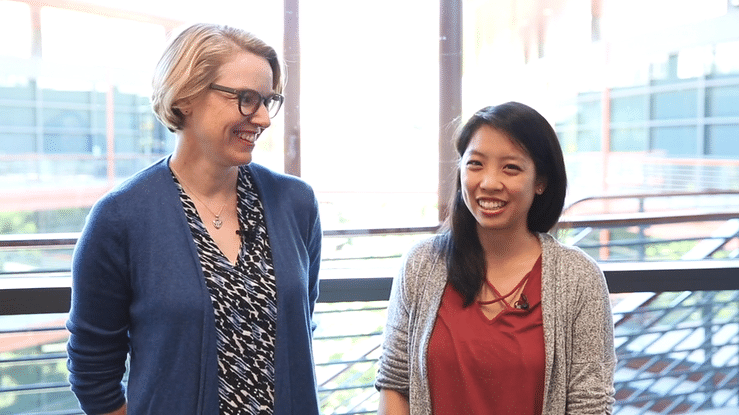 Moving gif image of a white female faculty member and an Asian female graduate student speaking to the camera at the Clark Center.