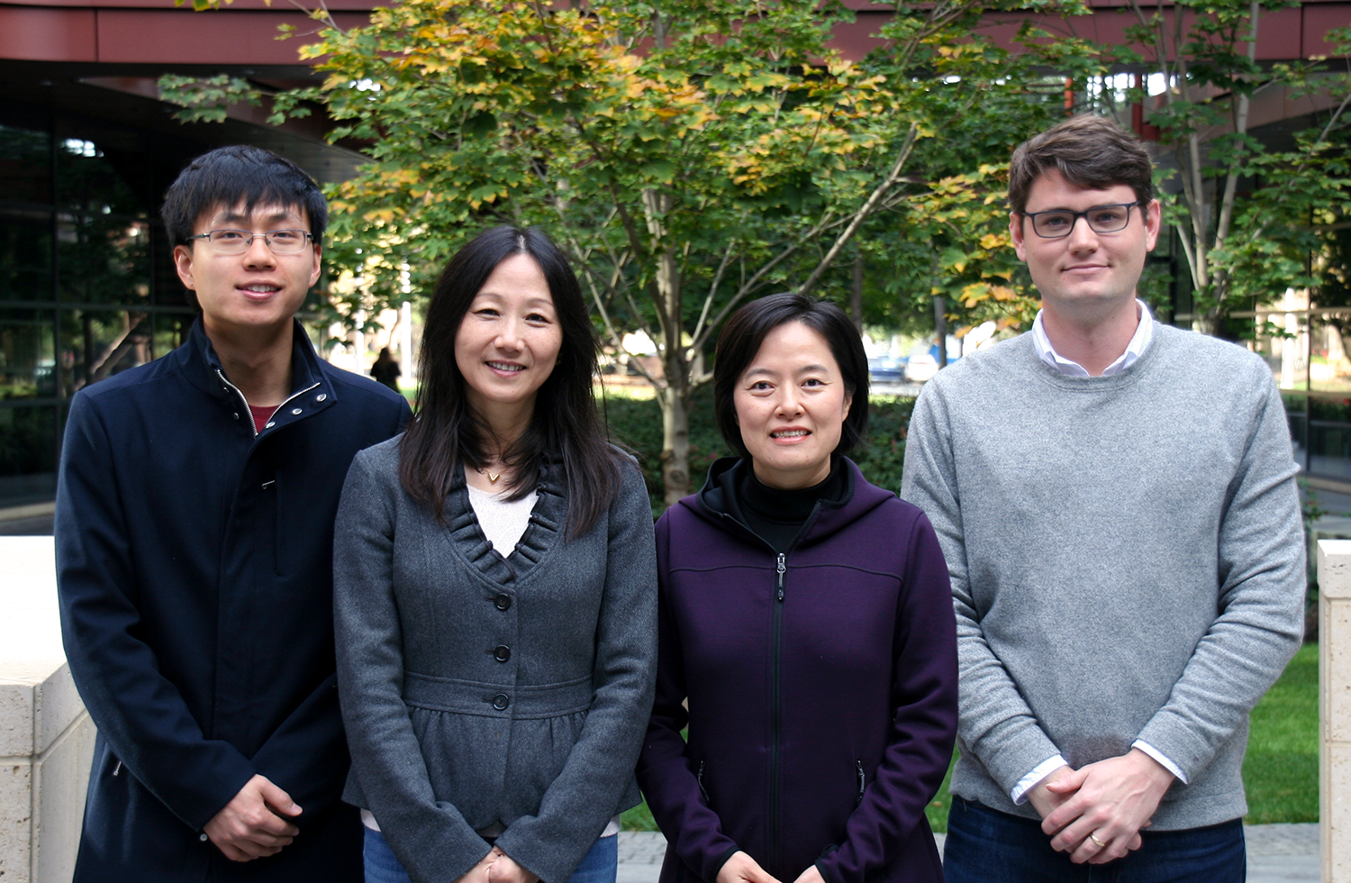 Still photo of Asian male graduate student, two Asian female faculty members, and a white male graduate student standing together at the Clark Center.