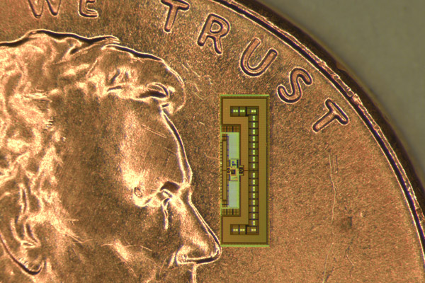 Photo of tiny radio chip on a penny.