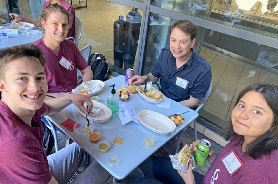 Photo of USRP students lunching with a faculty member