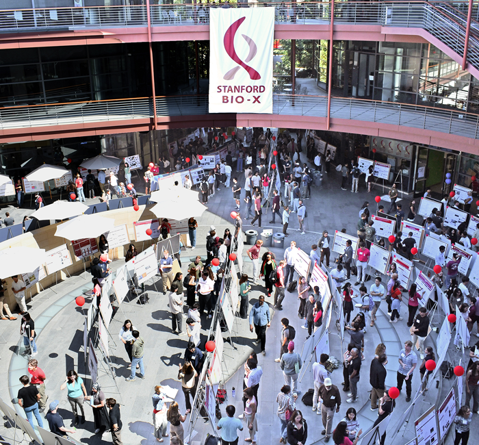 Outdoor photo of researchers browsing hundreds of scientific posters.