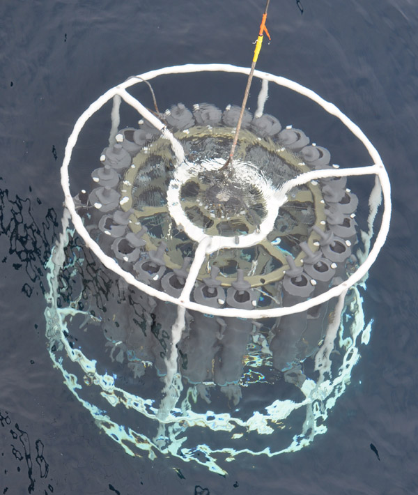 Photo of the large sampler device plunging into the water.