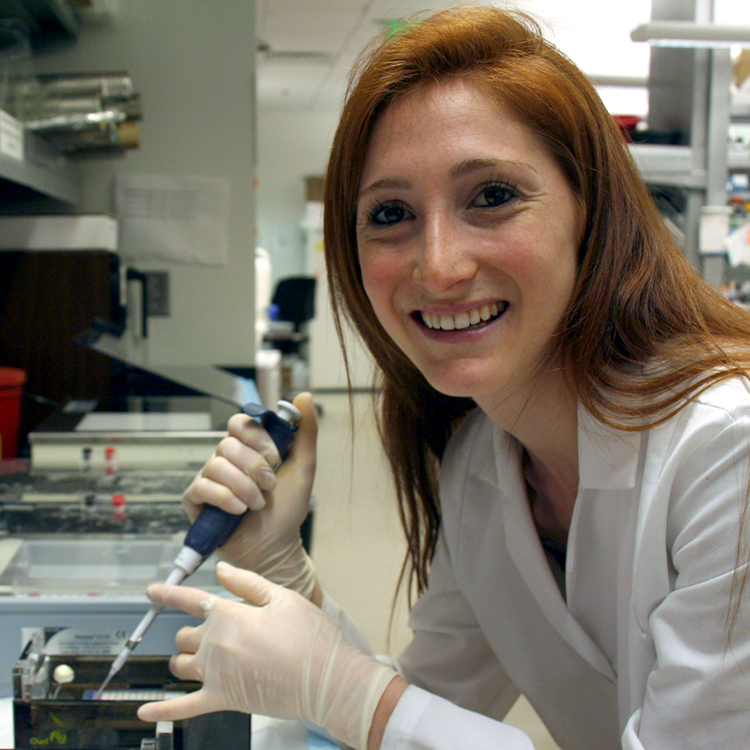 Photo of USRP student Nira Krasnow in the lab, pipetting solution.
