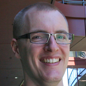 Headshot photo of young Danish man in glasses.