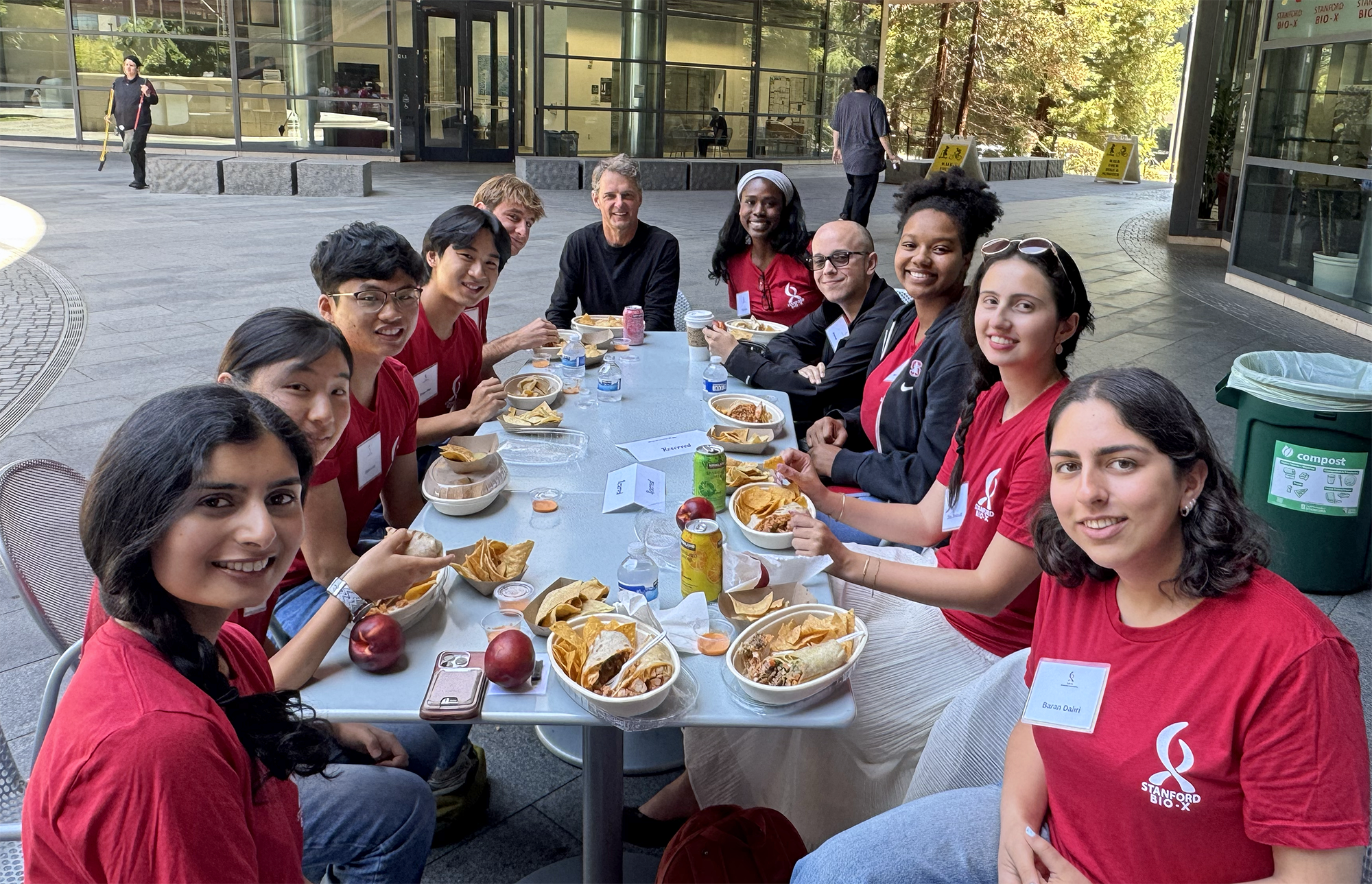 Photo of USRP students lunching with a faculty member