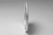 Photo of coin standing on its edge.