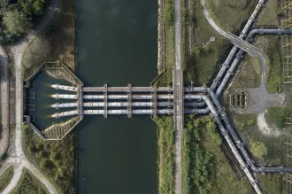 Overhead photograph of a water treatment plant with large intersecting pipes.