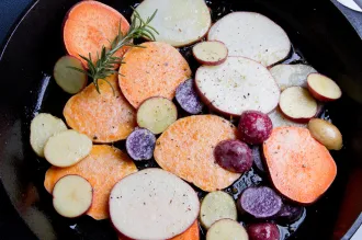 Photo of colorful potatoes being cooked in a pan.