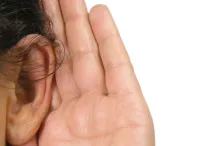 Photo of person experiencing hearing loss.