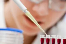 Photo of researcher testing blood samples.