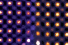 Colorized transmission electron microscopy of ceria ultrathin film, showing atoms as yellow and orange dots against purple.