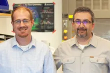 Photo of Drs. Aaron Newman and Ash Alizadeh standing in a laboratory space.