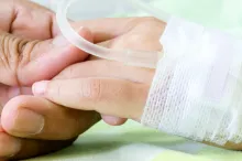 Photo of hand of child in hospital.