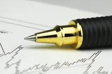 Photo of pen on top of scientific graph.