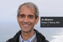 Image of Dr. Krishna Shenoy outdoors, smiling at the camera, with text reading "In Memory: Dr. Krishna V. Shenoy, 1968-2023."