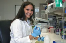 Photo of graduate student Teresa Purzner using a pipette.