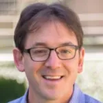 Photo of a smiling white male faculty member with short brown hair and glasses, Dr. Aaron Lindenberg, Professor of Materials Science & Engineering and Photon Science at Stanford University.