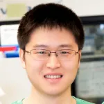 Photo of smiling Asian male faculty member, Dr. Alex Gao, Assistant Professor of Biochemistry at Stanford.