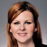 Headshot photo of a smiling white female faculty member with long red hair, Dr. Amanda Kirane, Assistant Professor of Surgery at Stanford University.