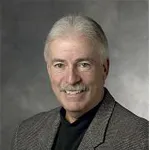 Indoor headshot photo of a smiling white male faculty member, Dr. Thomas Andriacchi, Professor Emeritus of Mechanical Engineering and Orthopaedic Surgery.