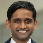 Indoor headshot photo of a smiling Southeast Asian faculty member, Dr. Ashwin Ramayya, Assistant Professor of Neurosurgery at Stanford University.