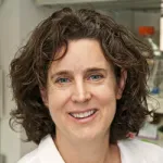 Indoor headshot photo of a smiling white female faculty member, Dr. Catherine Blish, Professor of Medicine at Stanford University.