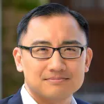 Photo of smiling male faculty member, Dr. Daniel Ho, Professor at the Stanford Law School and of Political Science at Stanford University.