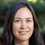 Outdoor headshot photo of a smiling female faculty member, Dr. Jade Benjamin-Chung, Assistant Professor of Epidemiology and Public Health at Stanford University.