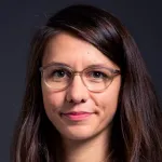 Headshot photo of a smiling white female faculty member with long dark hair and glasses, Dr. Jeannette Bohg, Assistant Professor of Computer Science at Stanford University.