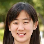 Outdoor headshot photo of a smiling Asian female faculty member, Dr. Jin Hyung Lee, Associate Professor of Neurology at Stanford University.