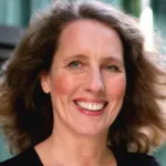 Photo of smiling white female faculty member with shoulder-length brown hair, Dr. Karla Kirkegaard, Professor of Genetics and Microbiology & Immunology at Stanford University.