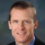 Photo of smiling white male faculty member with close-cropped dark hair, Dr. Kevin Shea, Professor of Orthopaedic Surgery at Stanford University.