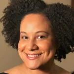 Indoor headshot photo of a smiling Black female faculty member, Dr. Lauren Goins, Assistant Professor of Developmental Biology.