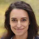 Photo of a smiling white female faculty member with long brown hair, Dr. Lauren O'Connell, Assistant Professor of Biology at Stanford University.