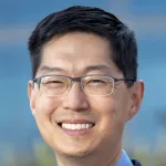 Photo of a smiling male Asian faculty member with short black hair and glasses, Dr. Michael Lim, Professor of Neurosurgery at Stanford University.