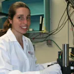 Indoor photo of a white female graduate student in the lab.