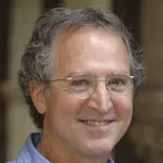 Photo of smiling white male faculty member with short gray hair, wearing glasses, Dr. David Relman, Professor of Medicine and Microbiology & Immunology at Stanford University.