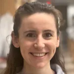 Indoor headshot photo of a smiling white female faculty member, Dr. Sarah Bowling, Assistant Professor of Developmental Biology at Stanford University.