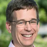 Outdoor headshot photo of a smiling white male faculty member, Dr. Stephen Luby, Professor of Medicine (Infectious Diseases) at Stanford University.