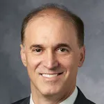 Indoor headshot photo of a smiling white male faculty member, Dr. Steven Artandi, Professor of Medicine and Biochemistry at Stanford University.