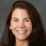 Indoor headshot photo of a smiling female faculty member, Dr. Tina Hernandez Boussard, Professor of Medicine at Stanford University.