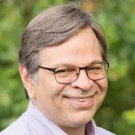 Headshot photo of smiling male faculty member Dr. Todd Martinez, Professor of Chemistry and Photon Science at Stanford University