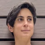 Outdoor headshot photo of a female facutly member with short dark hair, Dr. Vanessa Barone, Assistant Professor of Biology at Stanford University.