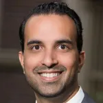 Outdoor headshot photo of an East Asian male faculty member, Dr. Vivek Buch, Assistant Professor of Neurosurgery at Stanford University.