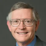 Photo of smiling white male faculty member with short gray hair and glasses, Dr. W. E. Moerner, Professor of Chemistry at Stanford University.