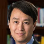 Indoor headshot photo of a smiling male Asian faculty member, Dr. William Kuo, Professor of Radiology at Stanford University.