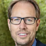 Outdoor headshot photo of a smiling white male faculty member, Dr. Tony Wyss-Coray, Professor of Neurology at Stanford University.