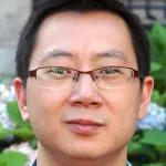 Photo of a smiling Asian male faculty member, Dr. Xiaoke Chen, Associate Professor of Biology at Stanford University.