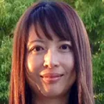 Outdoor headshot photo of a smiling female Asian faculty member, Dr. Xinnan Wang, Associate Professor of Neurosurgery at Stanford University.